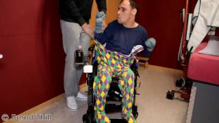 Strampler im Rollstuhl anziehen Guy with infantile cerebral palsy puts on romper suit  wheelchair [upl. by Aicile]