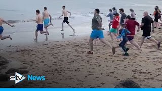 Hundreds of Scots brave the cold for Loony Dook dips [upl. by Trudey]