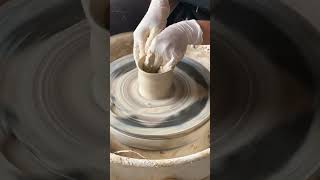 Ceramic artist is throwing a bud vase on the pottery wheel [upl. by Annasor]