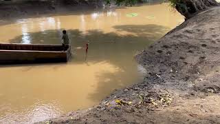 Young boys crossing river by small wooden boat [upl. by Nitsug731]