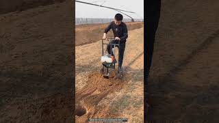 Drilling holes in the ground with a petrol drill [upl. by Bonner]