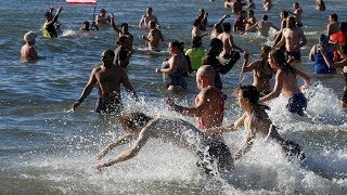 Swimmers take to the waters off Coney Island in annual Polar Bear Plunge [upl. by Ecydnarb]