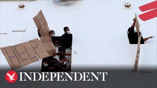 Migrants wave help signs as they are blocked from disembarking rescue ship in Sicily [upl. by Kirsteni]