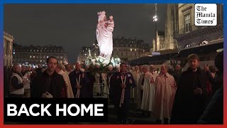 Candle procession returns Virgin Mary statue to rebuilt NotreDame Cathedral [upl. by Oiciruam]