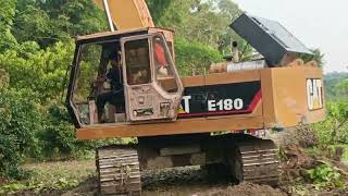 Caterpillar E180 excavator working canal bank for digging project [upl. by Walcott320]