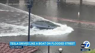 Tesla car plows through flooded San Diego street [upl. by Atirys]