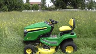 John Deere X350 mowing grass 45 feet tall yes it can do it [upl. by Neeuq270]