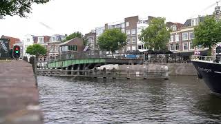 Haarlem Netherlands The swing swing bridge over the canal opens The ships begin to move Spaarne [upl. by Aicirt]