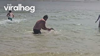 BareHanded Man Dives To Catch Fish  ViralHog [upl. by Collar]