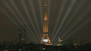 Eiffel Tower illuminates during the Olympic opening ceremony  AFP [upl. by Demodena651]