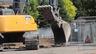 John Deere 350G Excavator ripping up a parking lot at a school construction site [upl. by Ardua]