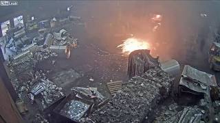 Foundry worker puts wet scrap metal in furnace [upl. by Sirod]