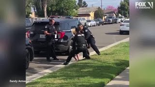 Police officers stop fellow officer punching handcuffed woman during arrest [upl. by Wilkey]