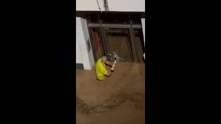 Man smashes glass door to save children in Spanish floods [upl. by Uzzi]